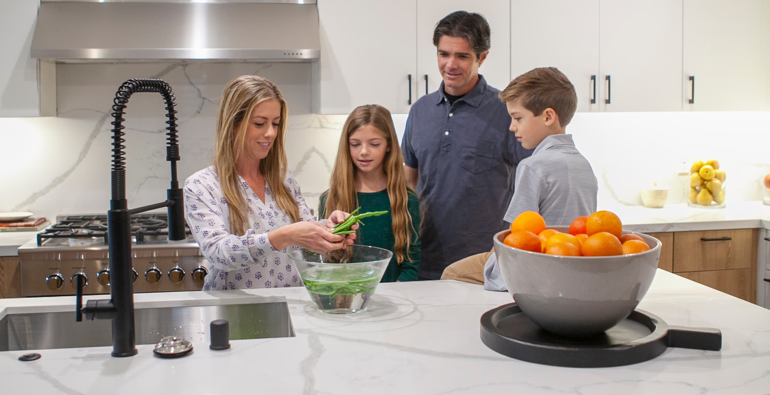 A family preparing fresh food together in a modern kitchen